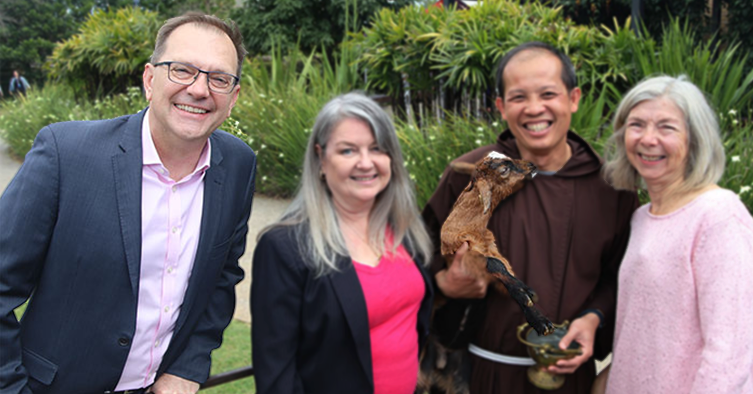 ACU Vice-Chancellor and President Zlatko Skribis posing with other people and a baby goat